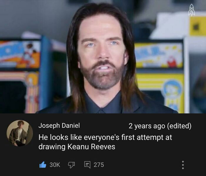 Hombre con barba y cabello largo, en video con comentario humorístico, mostrando insultos que no parecen por su genialidad.