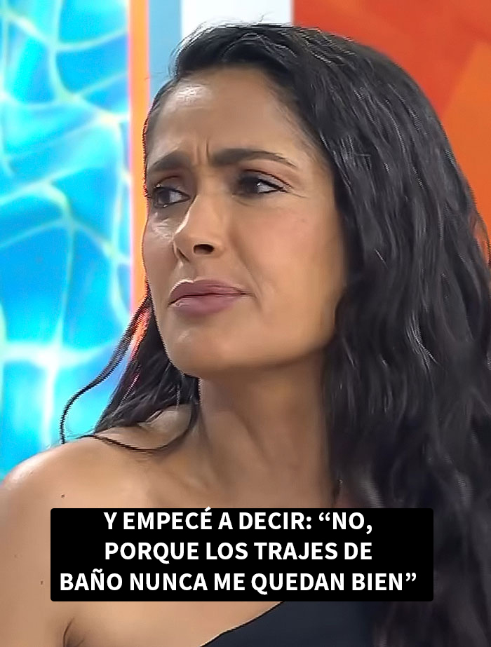 Salma Hayek con cabello rizado y expresión seria, hablando sobre su experiencia como modelo en Sports Illustrated Swimsuit.