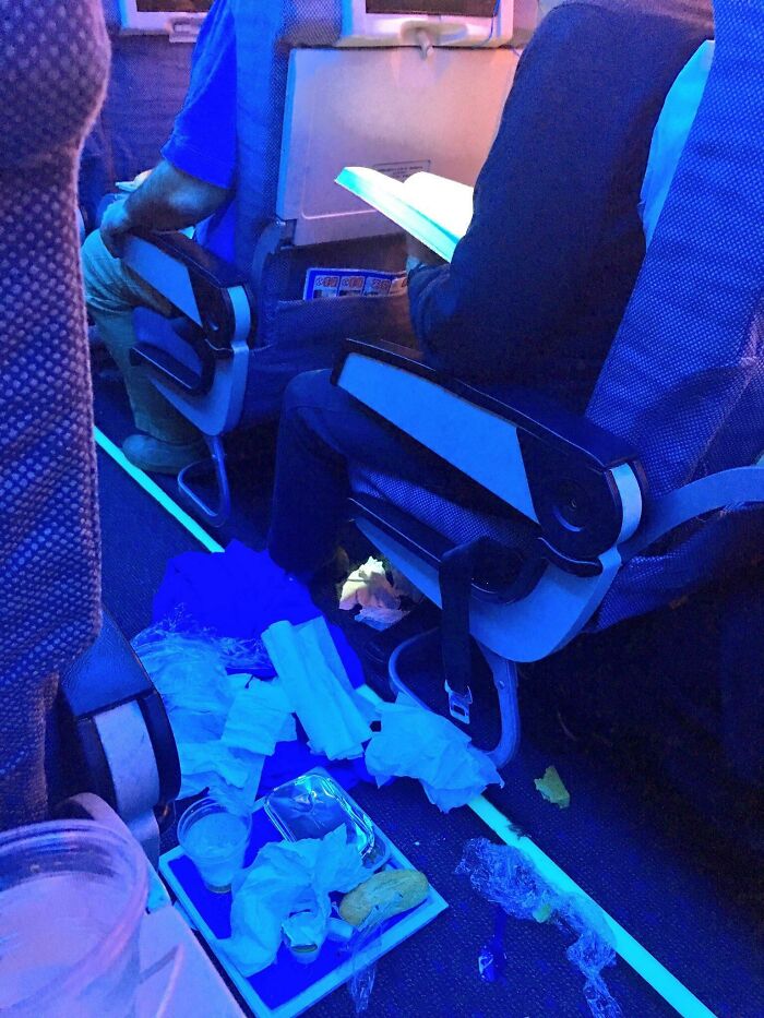 Este tipo en un avión comió y luego tiró el resto de la comida que no comió en el pasillo