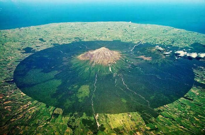 Volcán grande con sombra que cubre un área extensa, mostrando por qué las cosas extremadamente grandes pueden ser aterradoras.