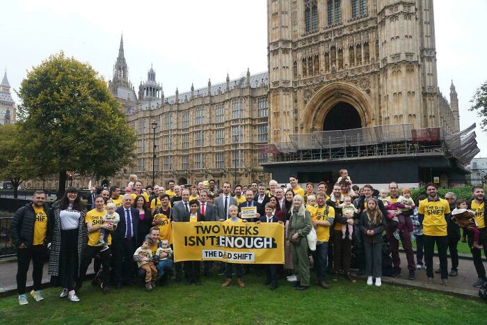 Grupo de padres en protesta mostrando momentos de padres divertidos y mejores momentos de crianza en familia.