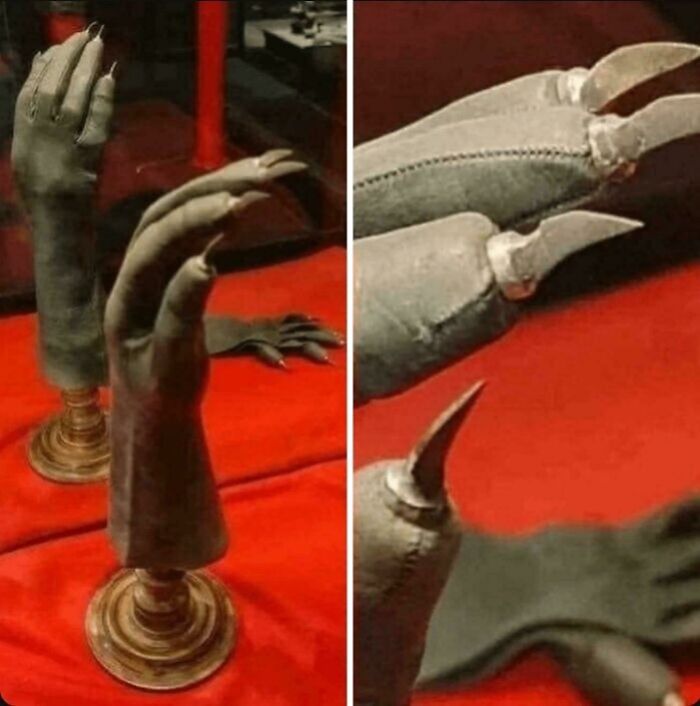 Guantes medievales en exhibición, destacando detalles de diseño histórico en una vitrina de museo.