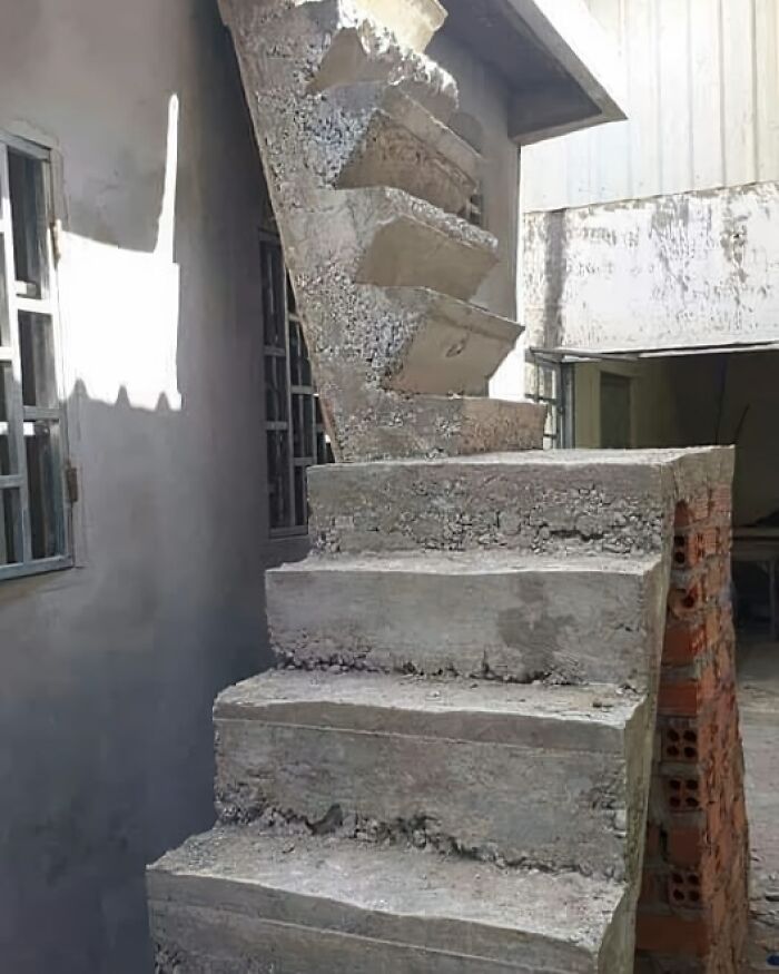 Escalera de cemento defectuosa, destacando un fallo de arquitectura notable y gracioso.