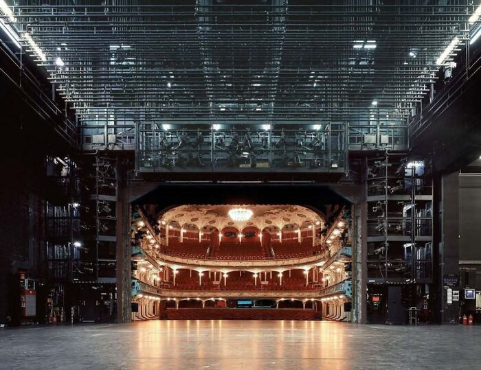 Vista del auditorio de un teatro desde el escenario, mostrando una perspectiva diferente del lugar conocido.