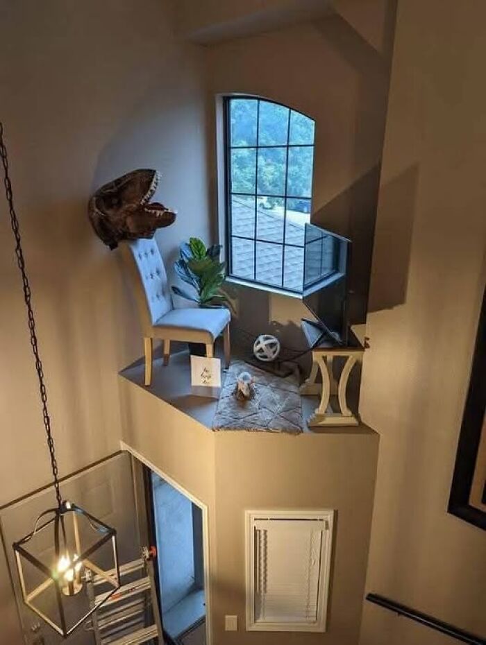 Espacio arquitectónico incómodo con detalles decorativos extraños junto a una ventana.