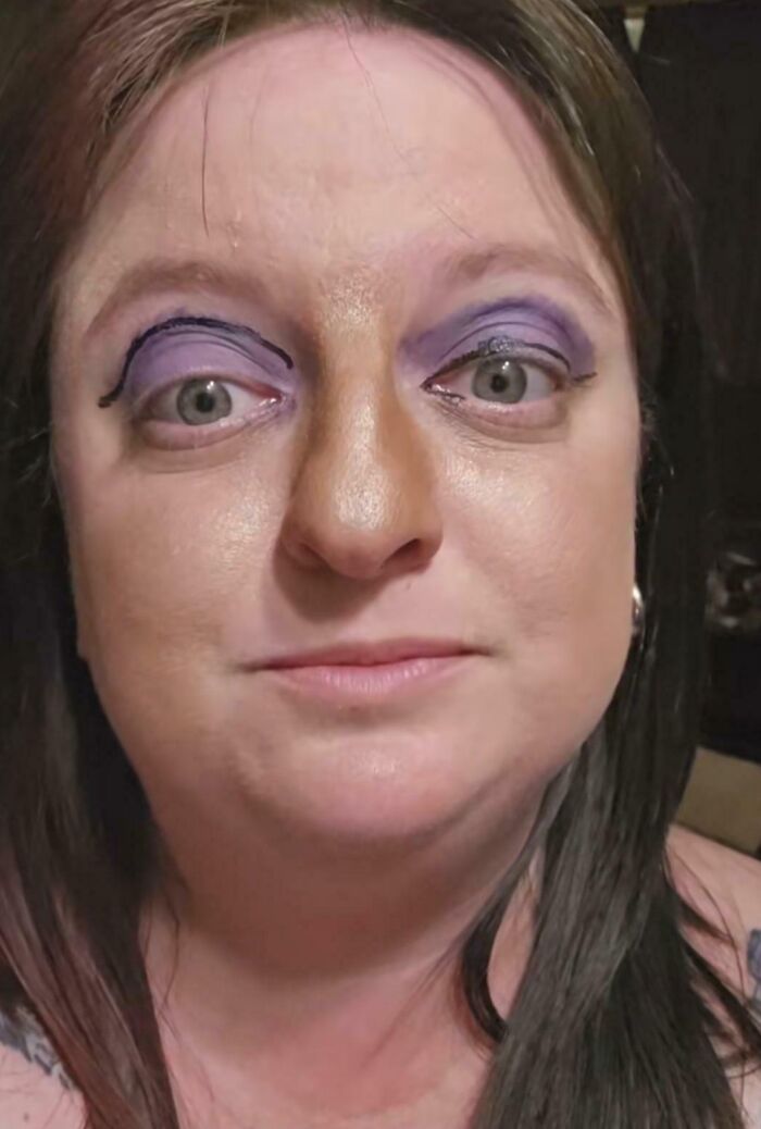 Mujer con maquillaje divertido en sus ojos, riendo por las travesuras de su esposo.