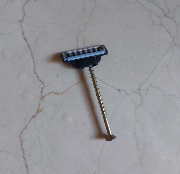 Cuchilla de afeitar improvisada con un tornillo para reparación fallida.