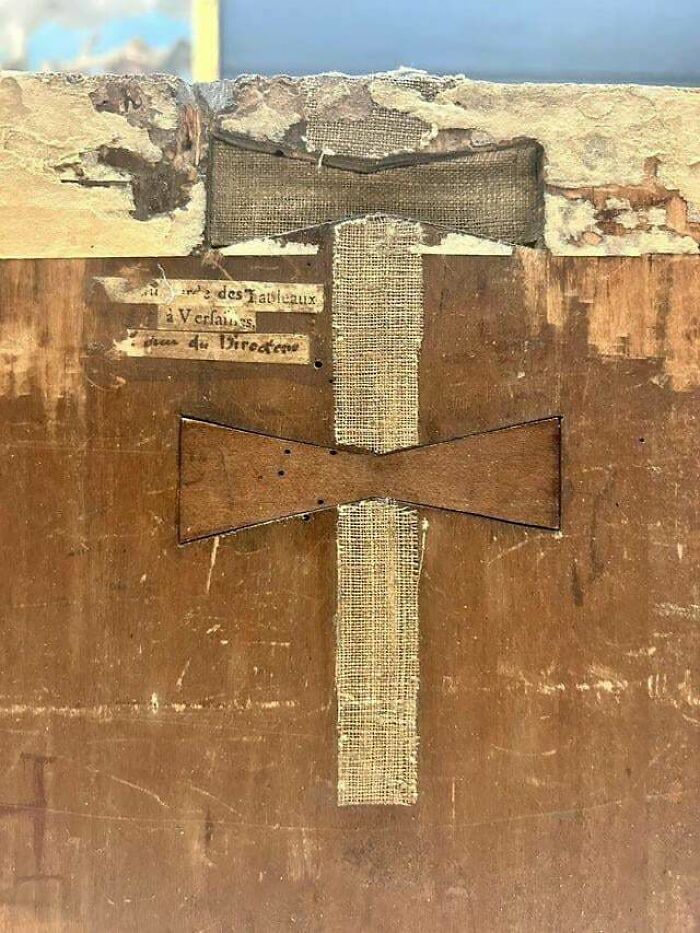 Parte trasera de una estructura de madera antigua reparada, mostrando texturas y detalles curiosos para ver desde otra perspectiva.