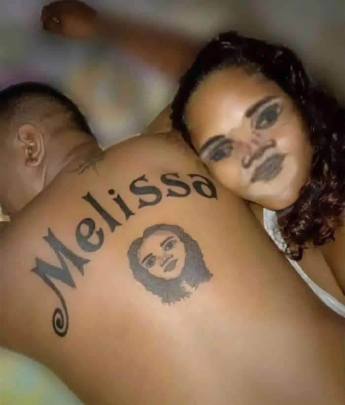Hombre con tatuaje de cara en la espalda, acompañado por mujer sonriente.