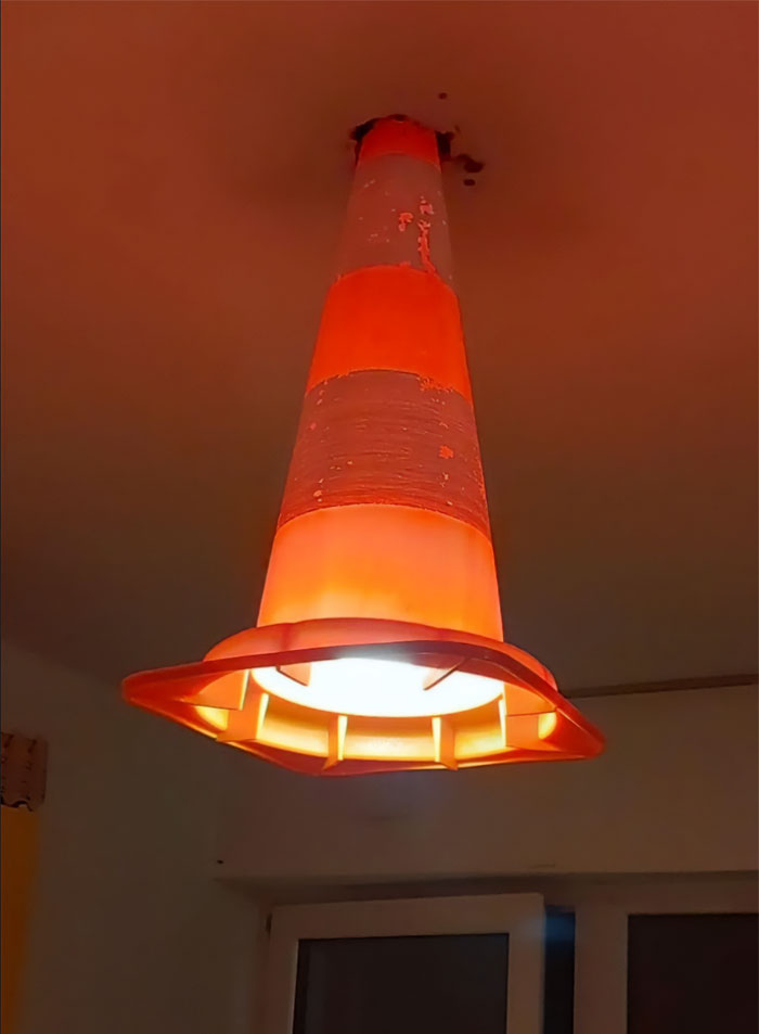 Cono de tráfico usado como lámpara improvisada en un intento de reparación.