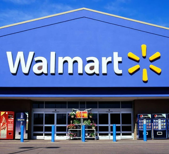 Walmart store exterior with bright signage on a sunny day.