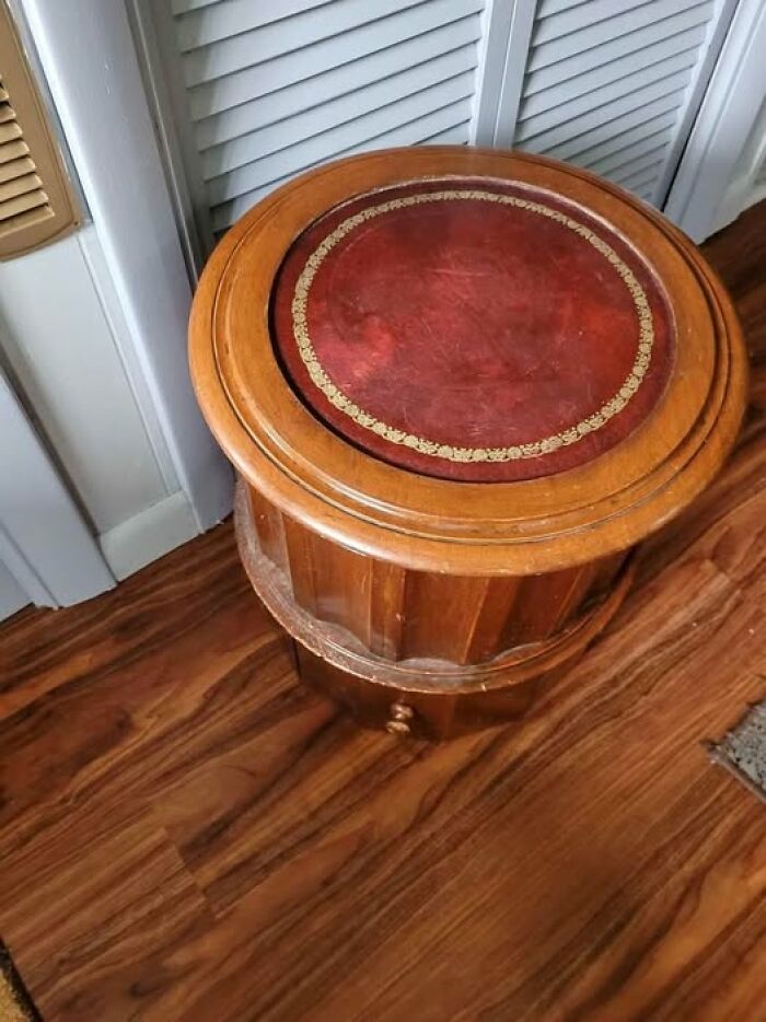 Mesa antigua redonda de madera con tapete rojo hallada en casas olvidadas o abandonadas, descubriendo secretos curiosos.