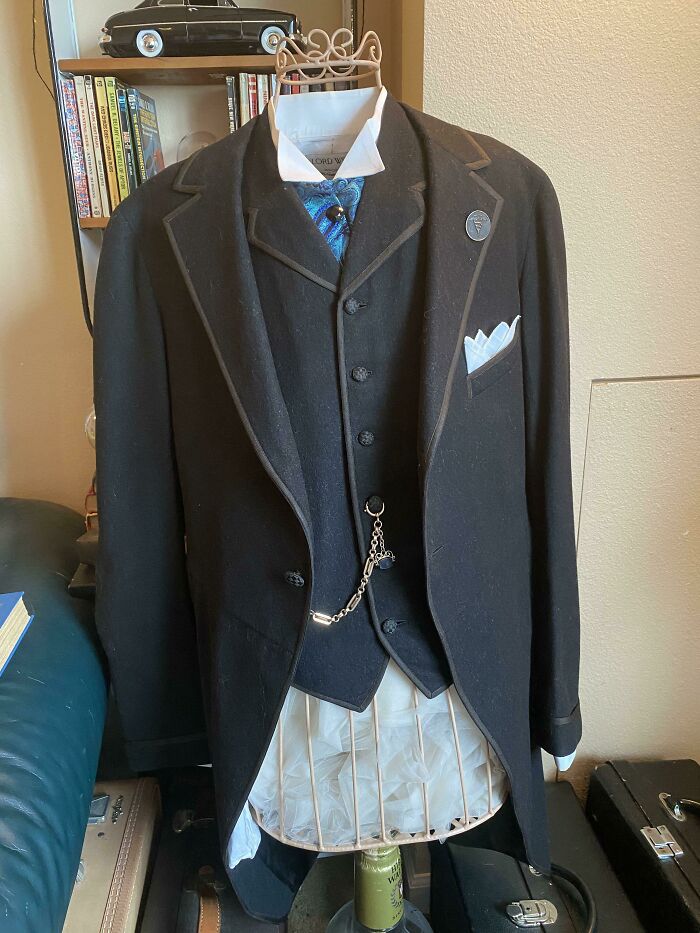 Traje antiguo de etiqueta con chaleco y reloj de bolsillo en maniquí, mostrando una nueva perspectiva temporal.