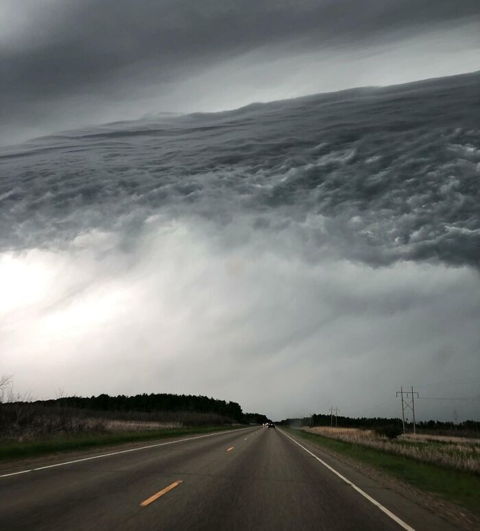 Nubes oscuras creando un efecto visual interesante que parece un paisaje diferente en esta carretera abierta.