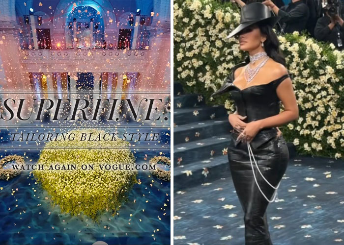 Mujer con vestido negro y sombrero en la Gala Met 2025, rodeada de flores y fotógrafos capturando momentos incómodos.