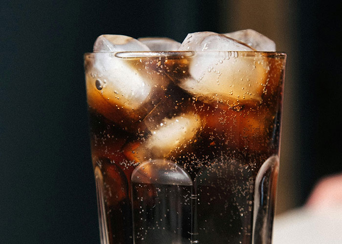 Vaso con bebida oscura y hielo en restaurante, escenario común en citas terribles contadas por camareros.