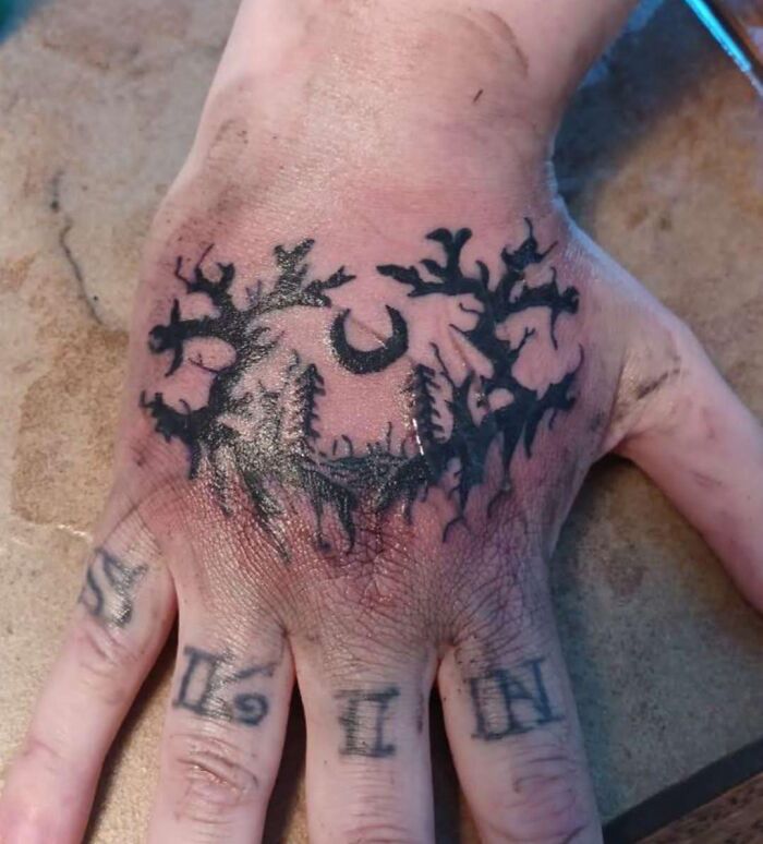 Tatuaje en mano con diseño oscuro y ramas, ejemplo de tatuajes horribles y errores difíciles de borrar en la piel.
