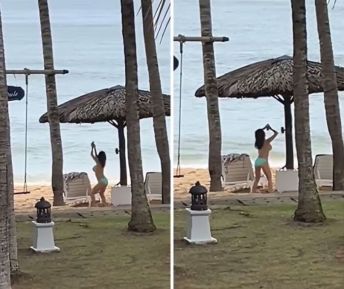 Influencer vergonzosa en bikini tomando fotos en la playa cerca de palmeras y sombrilla de paja junto al mar.