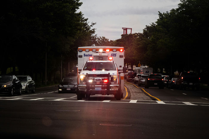 Ambulancia con luces encendidas en calle, representando situaciones de emergencia en hospitales con errores terribles.