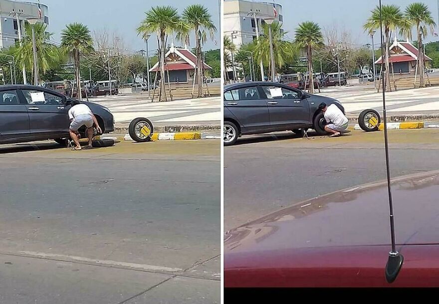 Hombre cambiando una llanta en la calle, mostrando una escena que parece de un futuro en el año 3019.