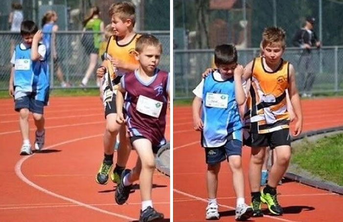 Niños corriendo y caminando en pista de atletismo en evento deportivo, imagen reconfortante para distraerte de horrores actuales.
