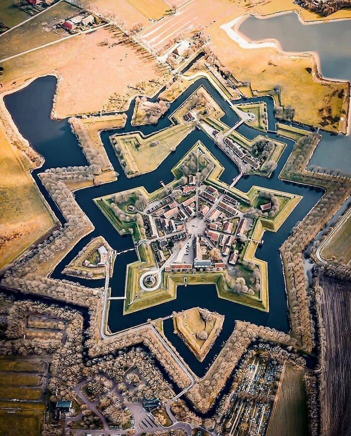 Vista aérea de una fortaleza en forma de estrella rodeada de agua, representando hechos históricos poco conocidos. Vista aérea de una fortaleza en forma de estrella rodeada de agua, representando hechos históricos poco conocidos.