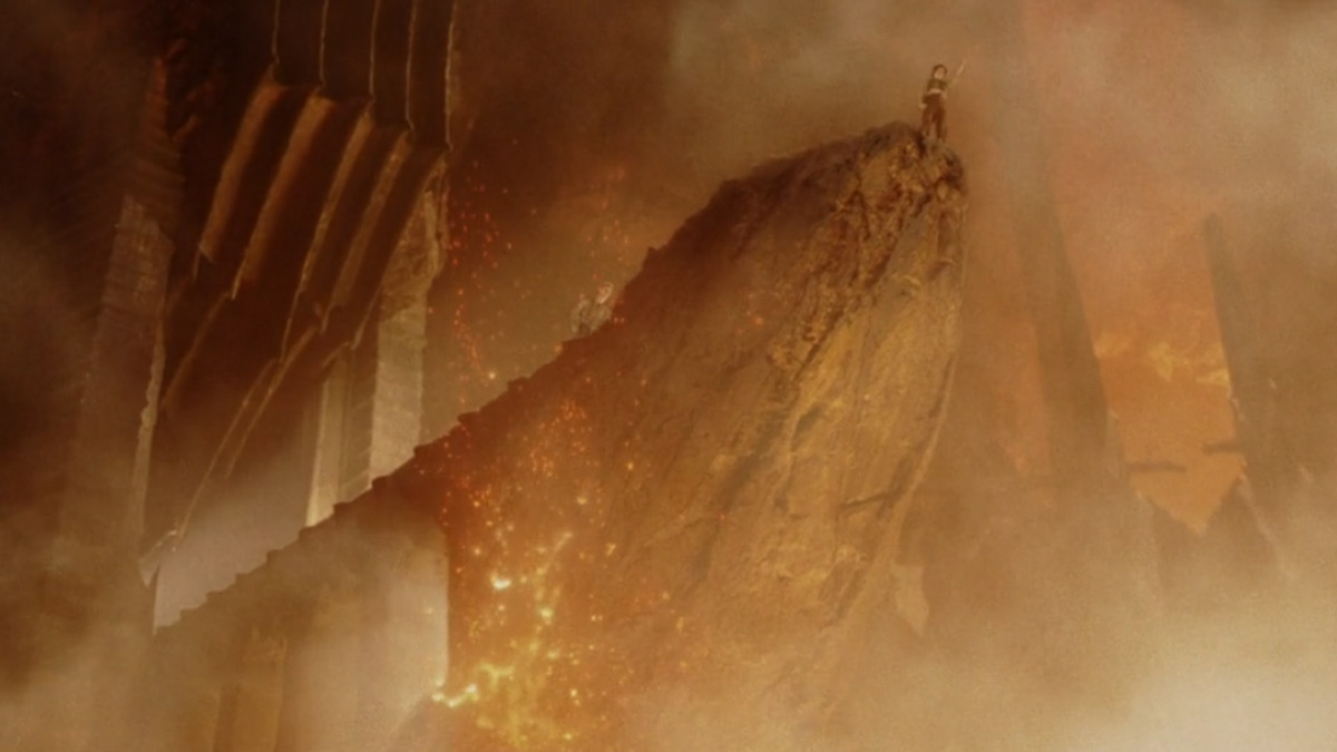 Personaje de El Seu00f1or de los Anillos en cima de roca gigante con ambiente de fuego y humo en escena u00e9pica.