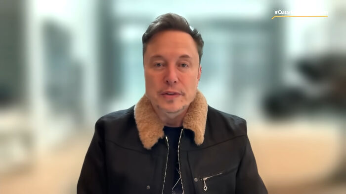 Hombre hablando en sesión virtual con chaqueta negra y cuello de piel, ilustrando decisiones malas que arruinaron vidas.