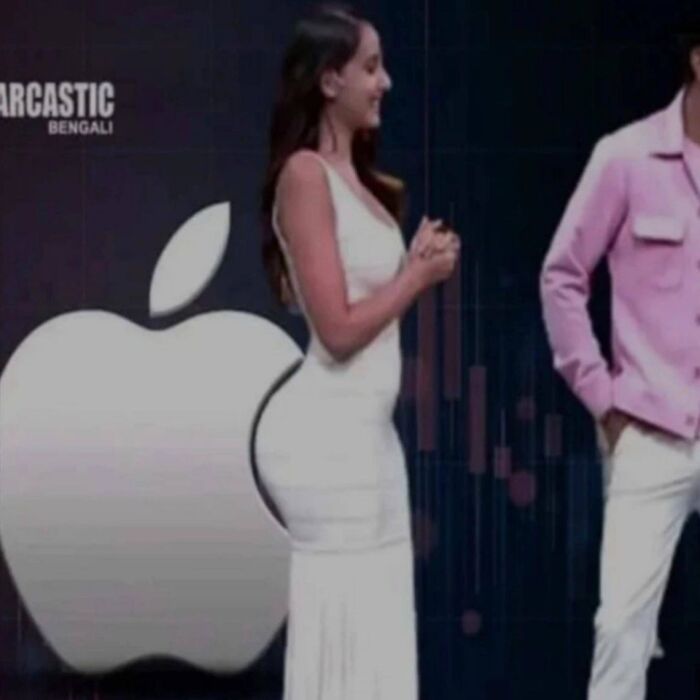 Mujer con vestido blanco frente a logo de Apple en imagen extraña y bizarra que no es para personas fácilmente ofendidas.