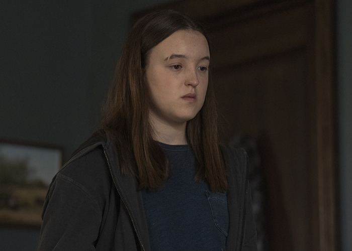 Joven con expresión seria en interior oscuro, ilustrando la pérdida de fanbase de celebridades rápidamente. Joven con expresión seria en interior oscuro, ilustrando la pérdida de fanbase de celebridades rápidamente.